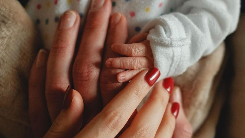 Die Hände von Ana Kohler, Luca Heubel und ihrem Baby