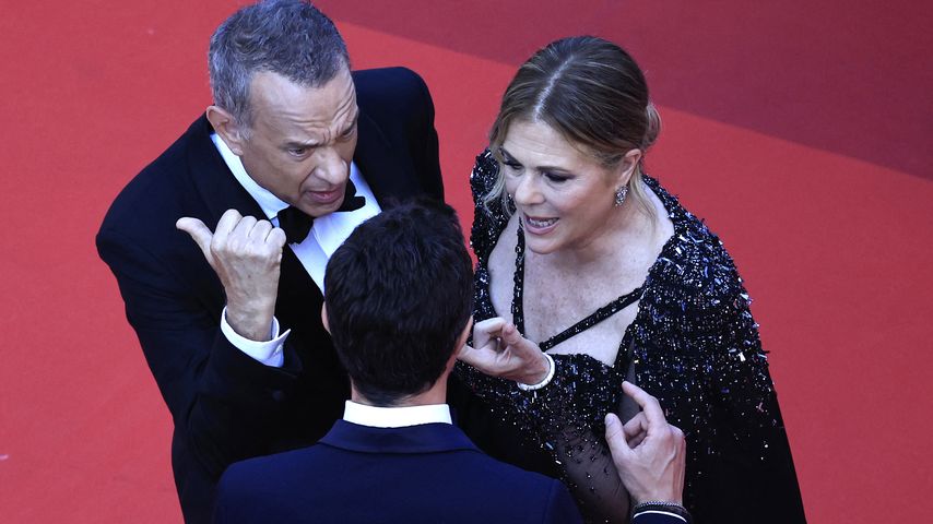 Ein Mitarbeiter der Filmfestspiele von Cannes, Tom Hanks und seine Frau auf dem Red Carpet