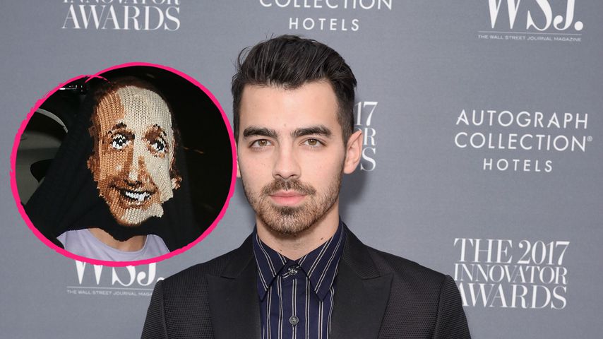 Joe Jonas versteckt sich unter seinem Pullover vor Paparazzi