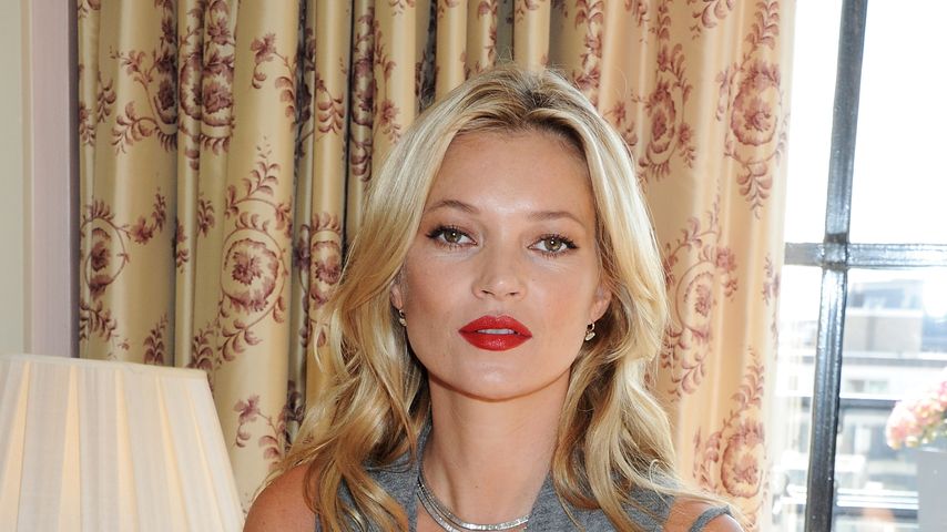 Kate Moss sitzt auf Couch