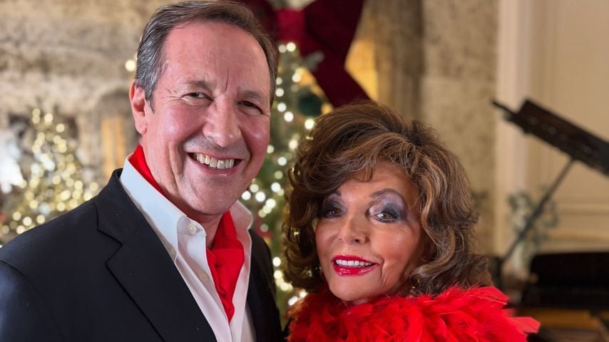 Percy Gibson und Joan Collins posieren