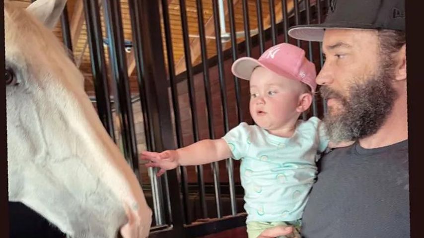 Tom Pelphrey und Tochter Matilda zeigen auf ein Pferd